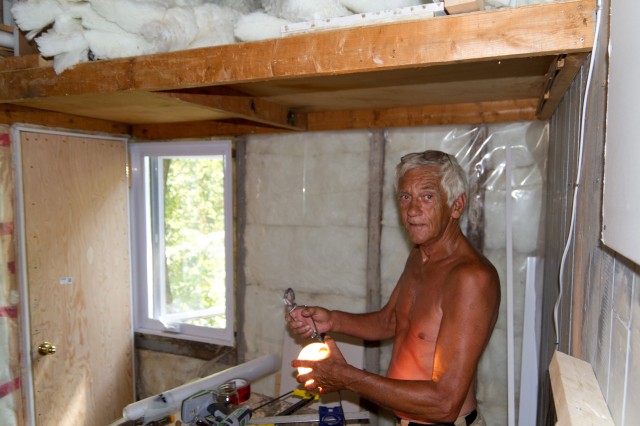 My dad with one of his epic tans. I think he was planning on upholstering a couch with a graft from his arms some day. He also showed me how to build that door from scratch because it wasn’t a standard size.<br />
