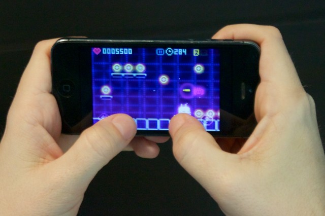 ...while playing on the iPhone 5 is much more cramped and causes your thumbs to block more of the action.