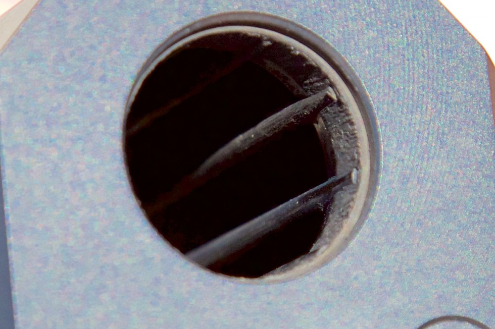 Rods visible through the business end of the Salvo shotgun suppressor. The rods guide the shell