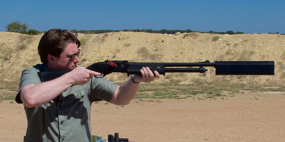 Firing a Remington 870 tactical shotgun with SilencerCo's Salvo suppressor. Note lack of hearing protection.