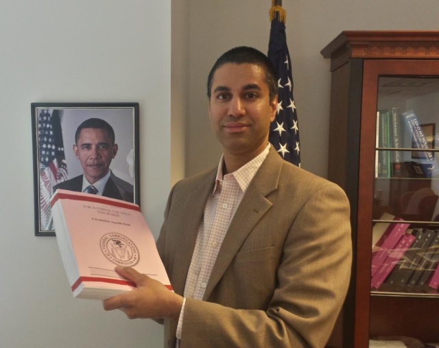 FCC Commissioner Ajit Pai holding up the FCC's net neutrality plan. 