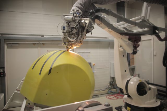 At GE Global Research Europe in Munich, this automated fiber placement robot does its thing—laying up fiber against a mold in complex patterns.