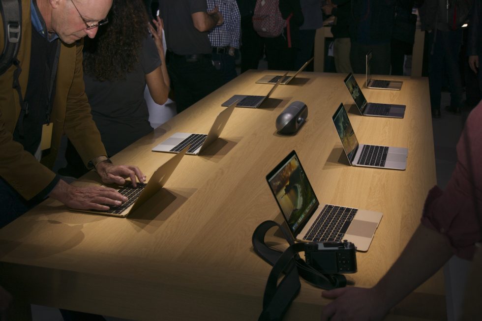 Observers play with the new Retina MacBooks.