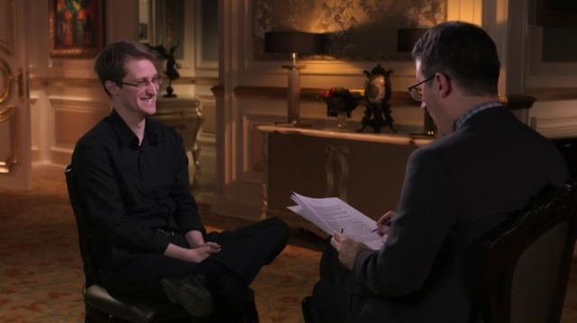 Edward Snowden and John Oliver share a laugh.