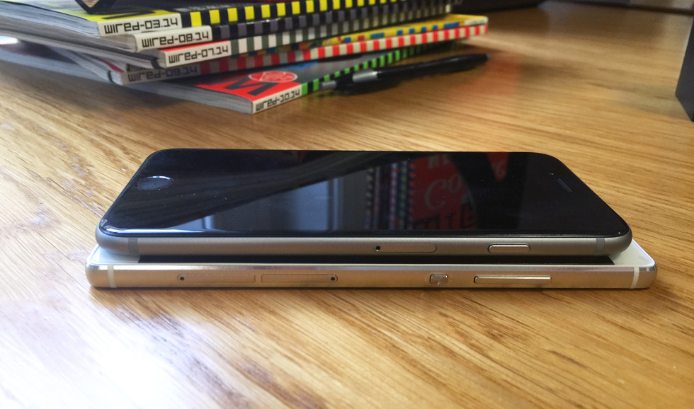 An iPhone 6 stacked on top of the Huawei P8.