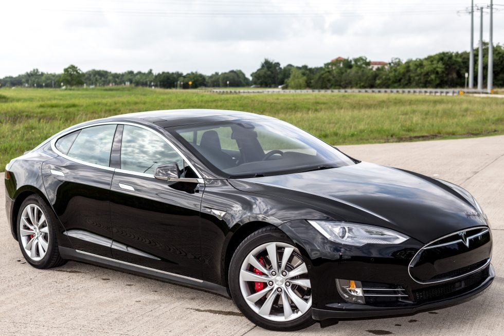 Our demo P85D, on loan from Tesla, with electricity stuff artfully framed in the background.