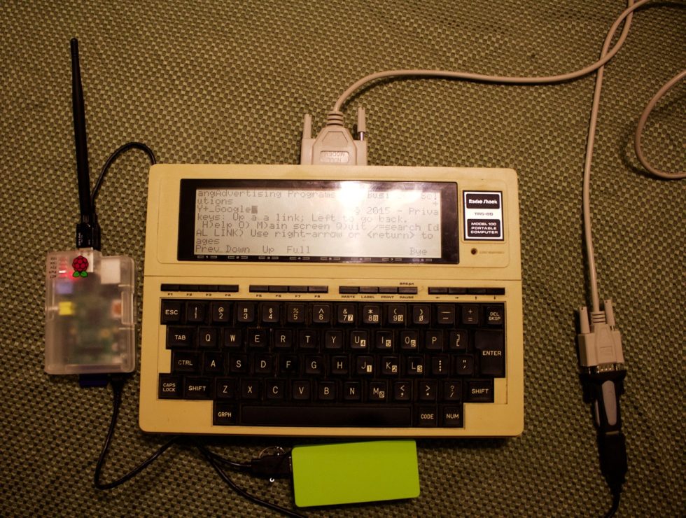 Mobility redefined: TRS-80 Model 100, Raspberry Pi B, a serial cable, a USB-to-serial converter, and a swag backup battery to power the Pi. Onscreen, I'm on Google's home page with Lynx.