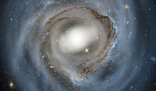 Verlinde makes some assumptions we know don't apply, like spherical symmetry—spiral galaxies are disks, not spheres.