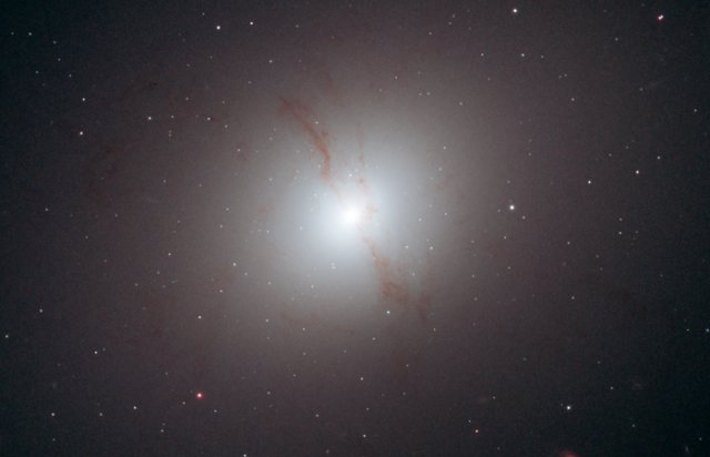 The two "dust lanes" through this galaxy suggest a recent merger, which can create a galaxy with two supermassive black holes.