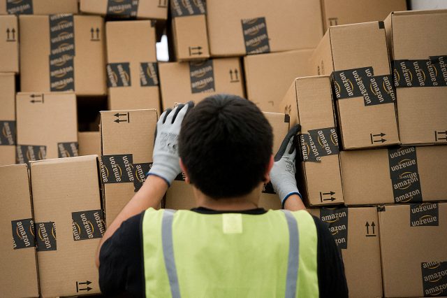 An employee loads a truck at an Amazon.com Inc. distribution center in Phoenix, Arizona in 2012. Photographer: David Paul Morris/Bloomberg via Getty Images