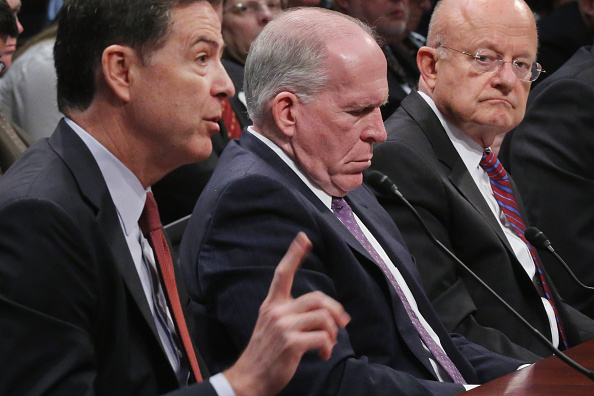 Director of National Intelligence James Clapper (far right) with CIA Director John Brennan (center) and FBI Director James Comey (left) before Congress last year. Clapper and Brennan have both now been targeted by hackers calling themselves "Crackas With Attitude". (Photo by Chip Somodevilla/Getty Images)