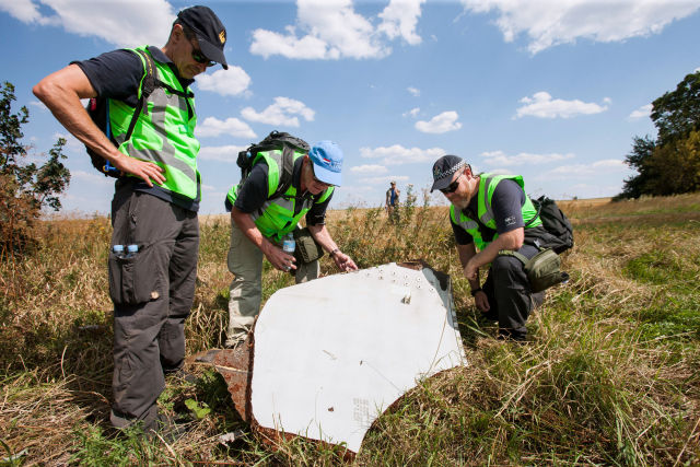 Dutch and Australian investigators in Ukraine last year at the site of the MH 17's debris field. A Russian "Buk" missile system was identified as the cause of the crash today.