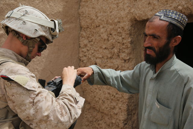 US Marine Corps Lance Cpl. Britain Morris, an infantryman with Fox Company, 2nd Battalion, 2nd Marine Regiment, "enrolls" an Afghan into the SEEK II system, part of the Navy and Marine Corps' Identity Dominance System, during a patrol in Washer, Helmand Province, Afghanistan, July 29, 2013.  The Marines are seeking an upgrade to their biometric toolkit.