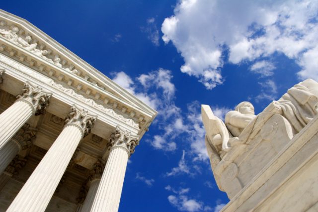 Statuary and facade outside neoclassical federal building.