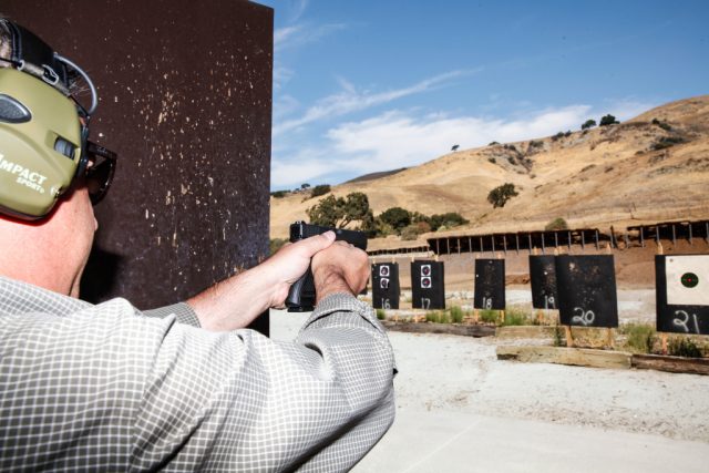 Jim Schaff of Yardarm demonstrates the sensor his company developed in place on a Glock 22 at a shooting range in San Jose, California, on Thursday, September 10, 2015. The sensor can alert dispatchers when an officer pulls his or her weapon and when shots have been fired and transmit the location back to dispatch.