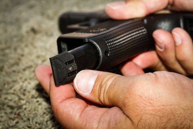 Jim Schaff of Yardarm shows off the sensor in place on a Glock 22 at a shooting range in San Jose, California, on Thursday, September 10, 2015. The sensor can alert dispatchers when an officer pulls his or her weapon and when shots have been fired and transmit the location back to dispatch.