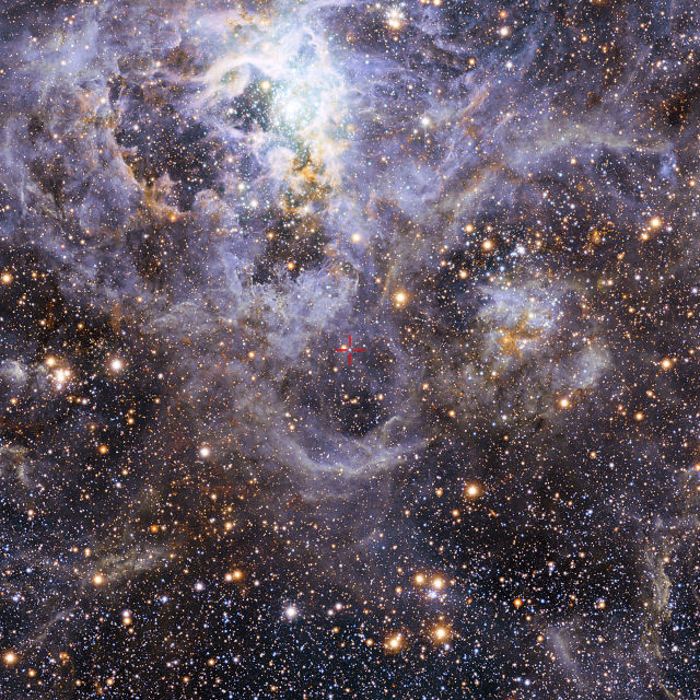 An image of the Tarantula nebula, taken with the MPG/ESO 2.2-meter Telescope in Heidelberg, Germany, showing the location of VFTS 352 in red crosshairs. 