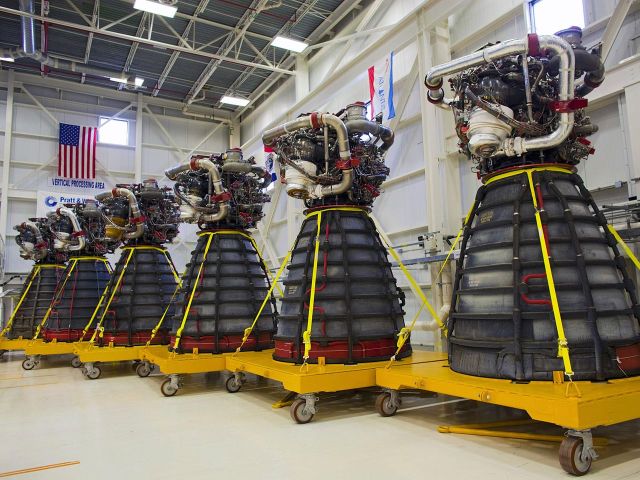 Six of the 18 reusable space shuttle engines NASA has in storage. Each will be used once by the SLS rocket, then discarded.