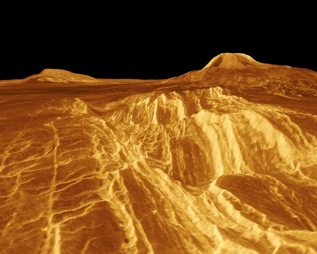 A computer-generated view of Venus' western Eistla Regio. The volcano on the right, Gula Mons, rises 3 km high.