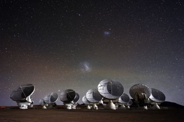 The ALMA Telescope’s antennas are seen under a starry night sky.
