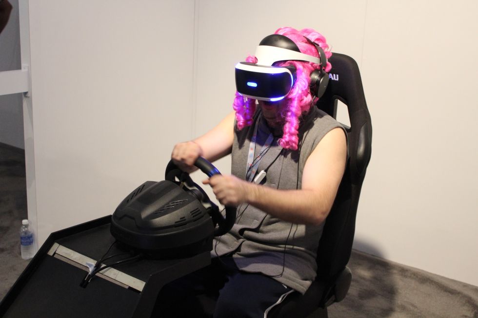 The <em>Driveclub VR</em> demo wasn't improved by its steering wheel and driving seat combo. Might've been better with that guy's wig, though.