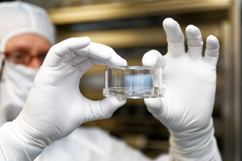 Ron Bastien holds an aerogel tile that flew into the tail of a comet, captured dust particles, and survived to tell the tale.