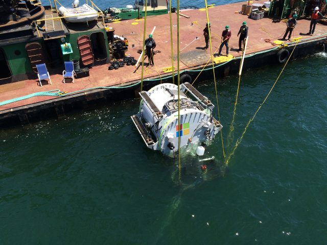 Lowering <em>Leona Philpot</em>, Microsoft's first underwater serverpod, into the water.