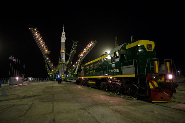 The portal arms close around the Soyuz spacecraft to secure the rocket to the launch pad on Wednesday.