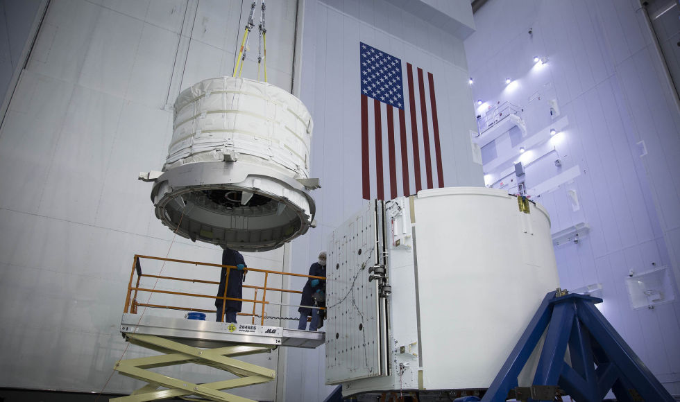 The expandable habitat from Bigelow Aerospace is lifted into Dragon's trunk for a ride to the space station.