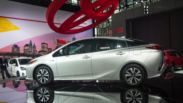 A Shiny New Compact Car Under A Massive Toyota Logo.