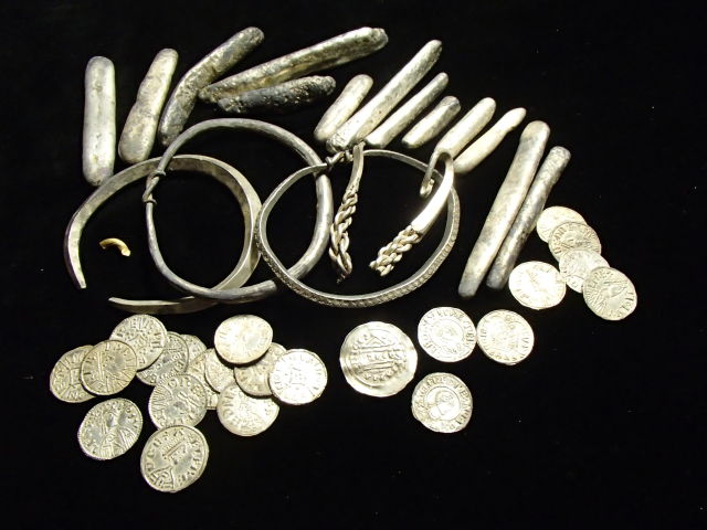 Part of the Viking hoard found in Watlington, including coins, ingots, and arm bands.