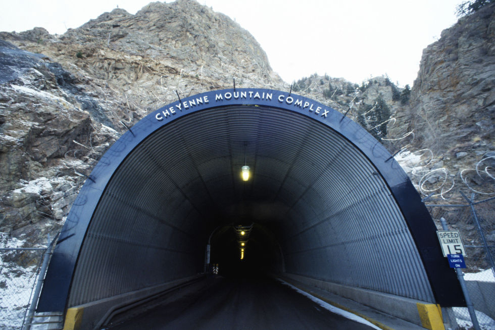 "The tunnel entrance to the North American Air Defense (NORAD) Space Command Cheyenne Mountain Complex." Utah Mining, the company that excavated Cheyenne Mountain, also built a civilian tunnel going from Denver to Idaho Springs. The dimensions of that tunnel entrance are similar to the dimensions of this tunnel entrance. 