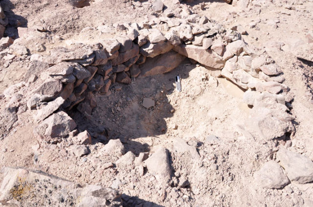 A close-up look at one of the pits in the Band of Holes. Each one is about 3 feet wide and 20 to 40 inches deep. They were not dug into the rock, but built from imported rocks and soil.