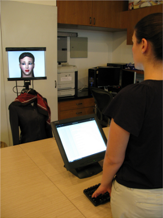 A participant interacts with a robot bearing Face 1.