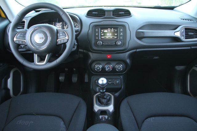 Jeep logos abound in the upholstery, on the dash, in the windows, in the trim, in the floor mats. Controls, seating, and plastics belie what you'd expect in this, the second-lowest-cost Jeep.