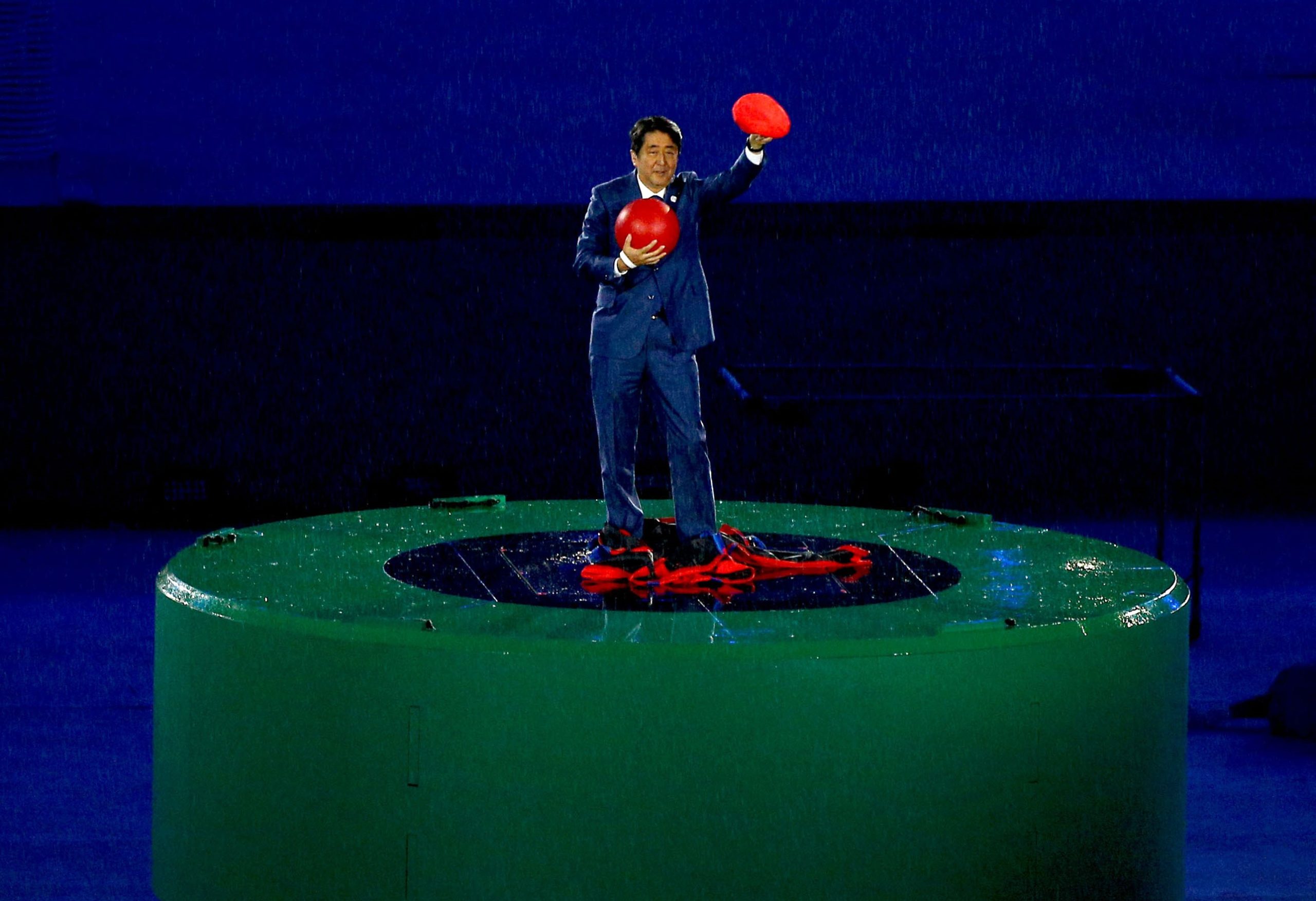 Japan's PM emerges from green pipe dressed as Mario, accepts