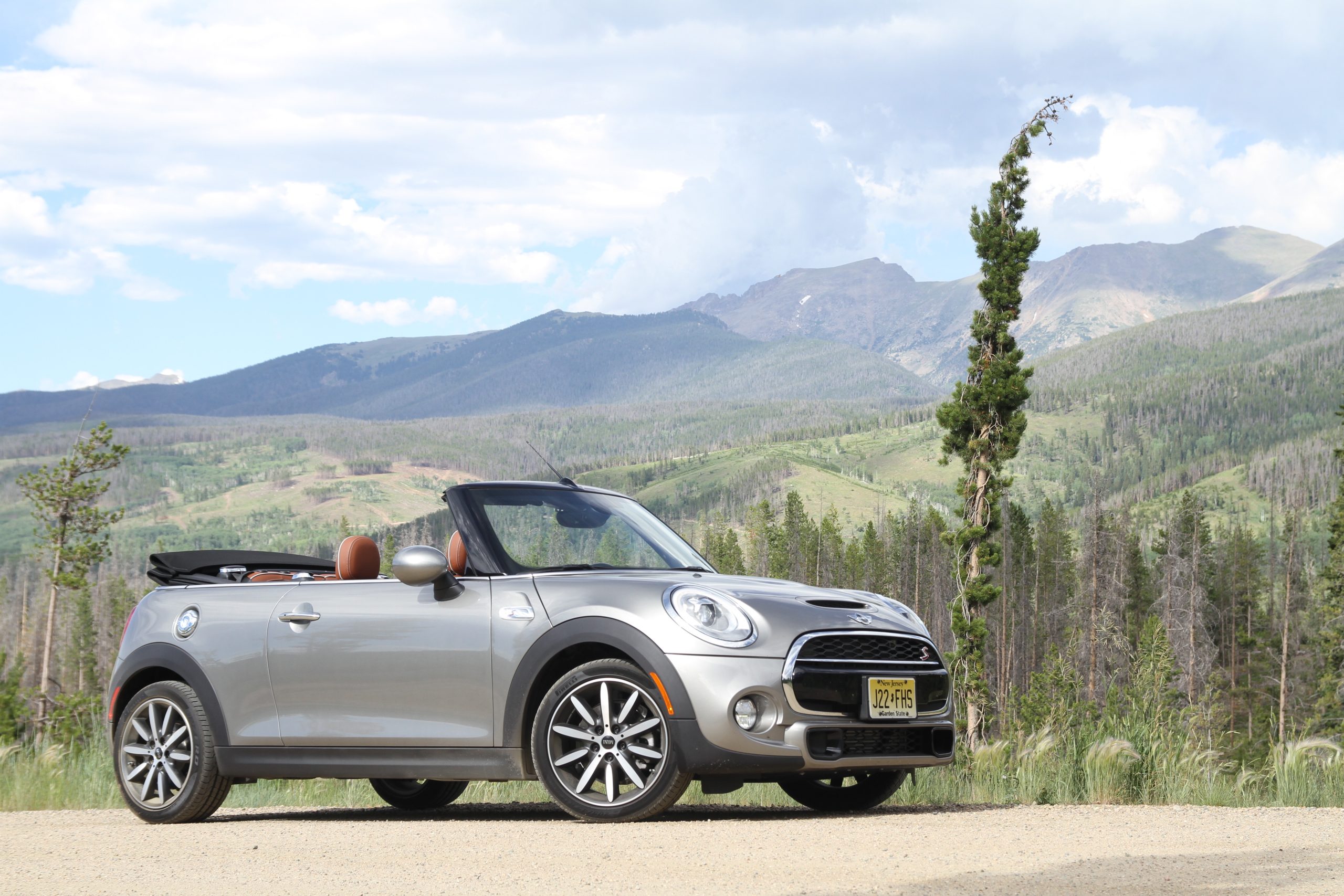 A Mini Cooper Convertible with its roof down, showcasing the open-top experience