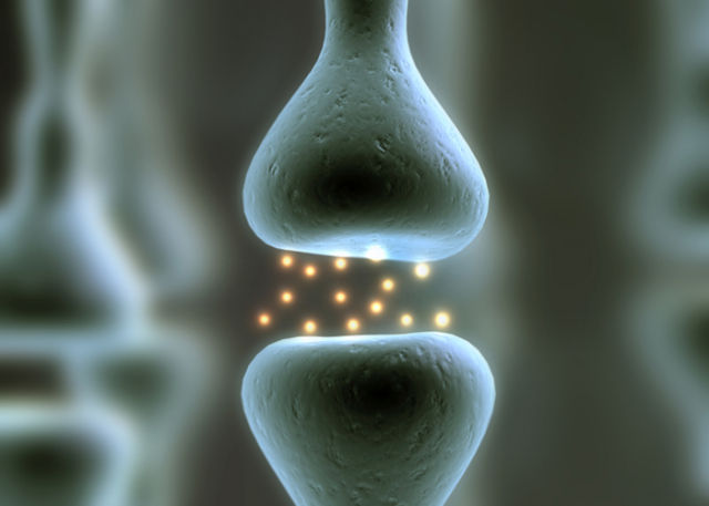 A cartoon representing neurotransmitters crossing a synapse.
