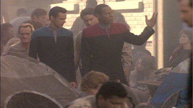 Sisko explains to Bashir that humans of the 21st century rebelled against the government that kept impoverished people in ghettos.