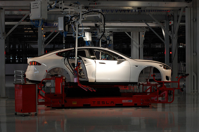 A car is worked on at the Tesla Factory in Fremont, CA.