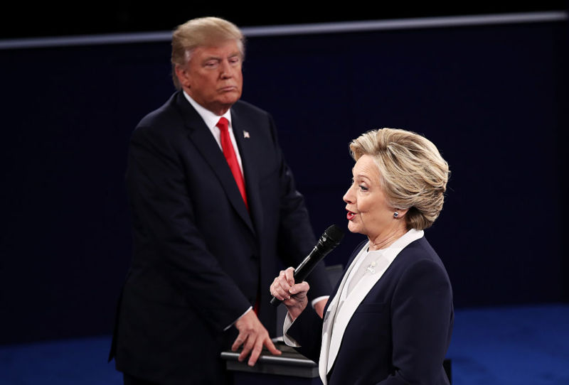 ST LOUIS, MO - OCTOBER 09:  Democratic presidential nominee former Secretary of State Hillary Clinton (R) speaks as Republican presidential nominee Donald Trump looks on during the town hall debate at Washington University on October 9, 2016 in St Louis, Missouri. 