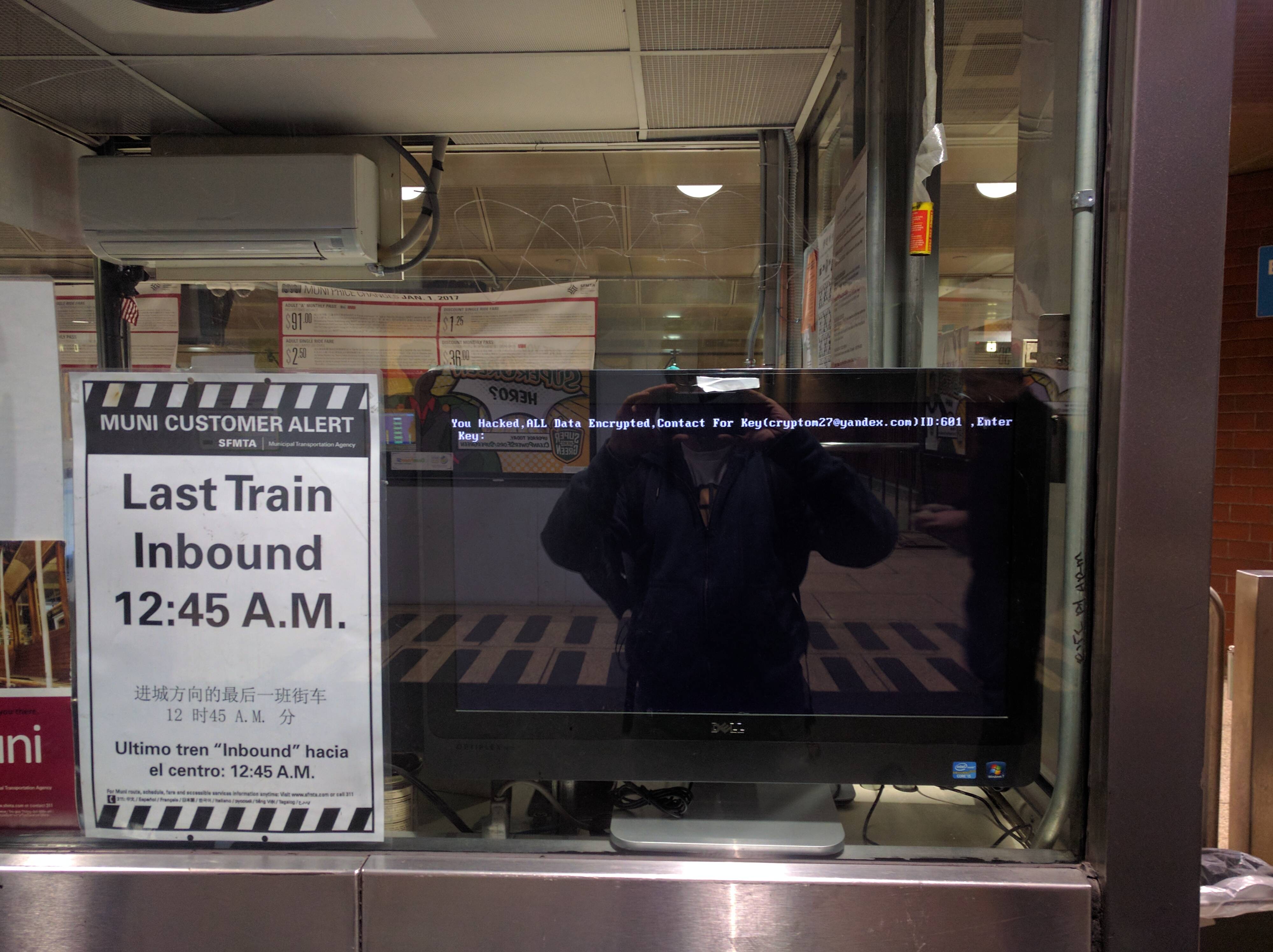 A screen at a Muni train station shows the malware message from HDDCryptor.