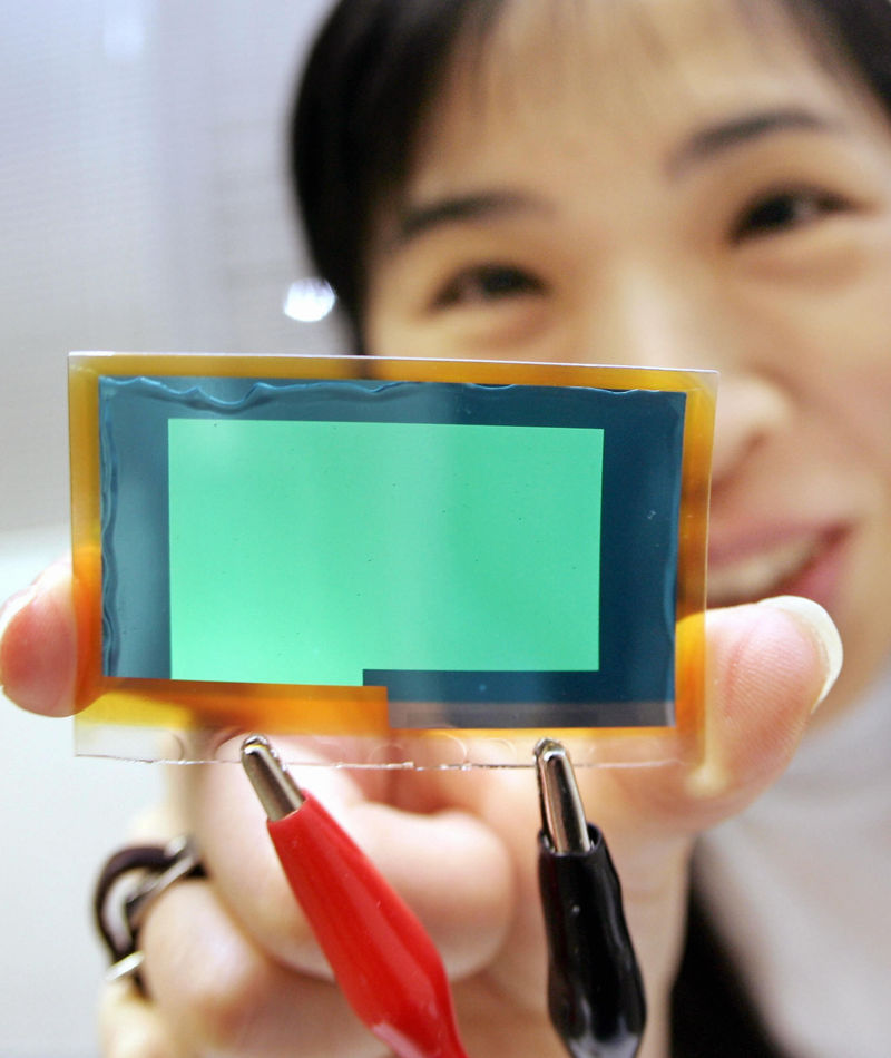 A 2005 photo of a Pioneer employee holding a bendable prototype of an OLED panel in Tsurugashima city, suburban Tokyo.