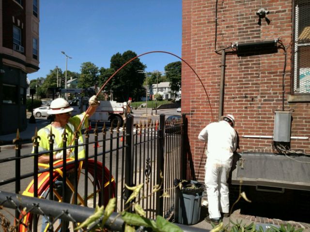 Verizon workers lay fiber underground in the Boston neighborhood of Roxbury.