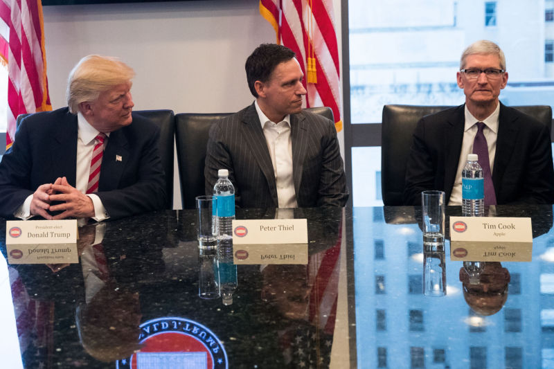 Tim Cook (right) looks engaged and enthusiastic sitting next to President-elect Donald Trump and Peter Thiel at Trump's tech summit in New York City last month.