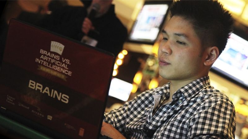 Online poker pro Dong Kim plays poker against an AI program in 2015. He lost to an updated program in this year's rematch event.