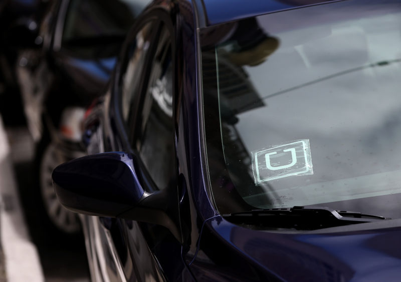 A sticker with the Uber logo is displayed in the window of a car on June 12, 2014 in San Francisco, California.