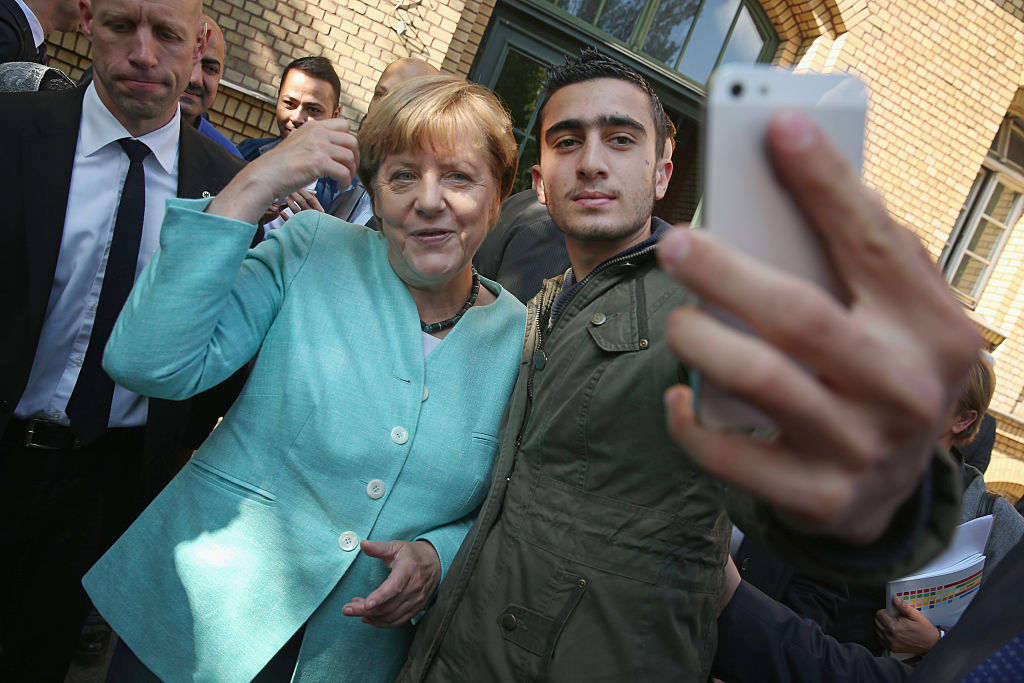 German Chancellor Angela Merkel poses for a selfie with Modamani on September 10, 2015 in Berlin, Germany. (Photo by Sean Gallup/Getty Images)