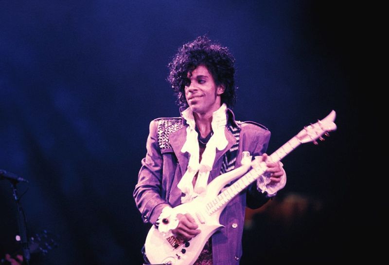 Prince performing on stage during the 1984 Purple Rain tour. 