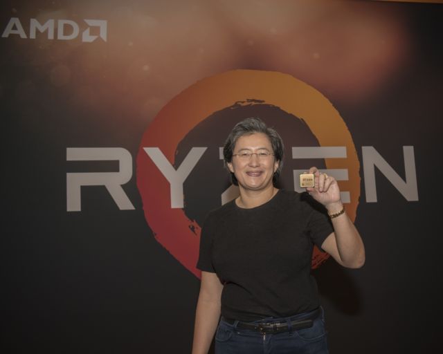 AMD CEO Lisa Su holding a Ryzen chip.